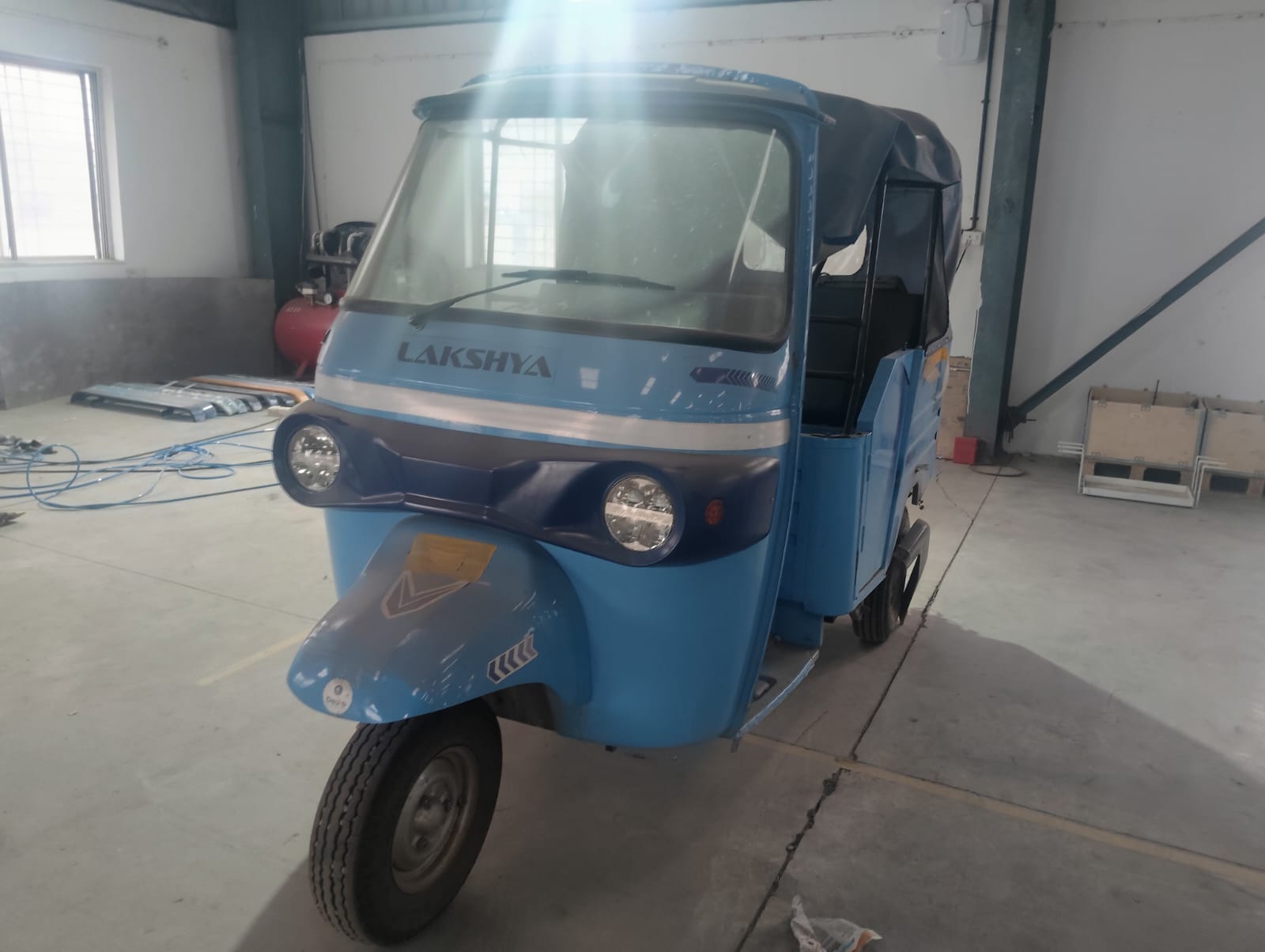 Lakshya electric passenger auto rickshaw prepared at an Ad Value Global associate EV assembly unit